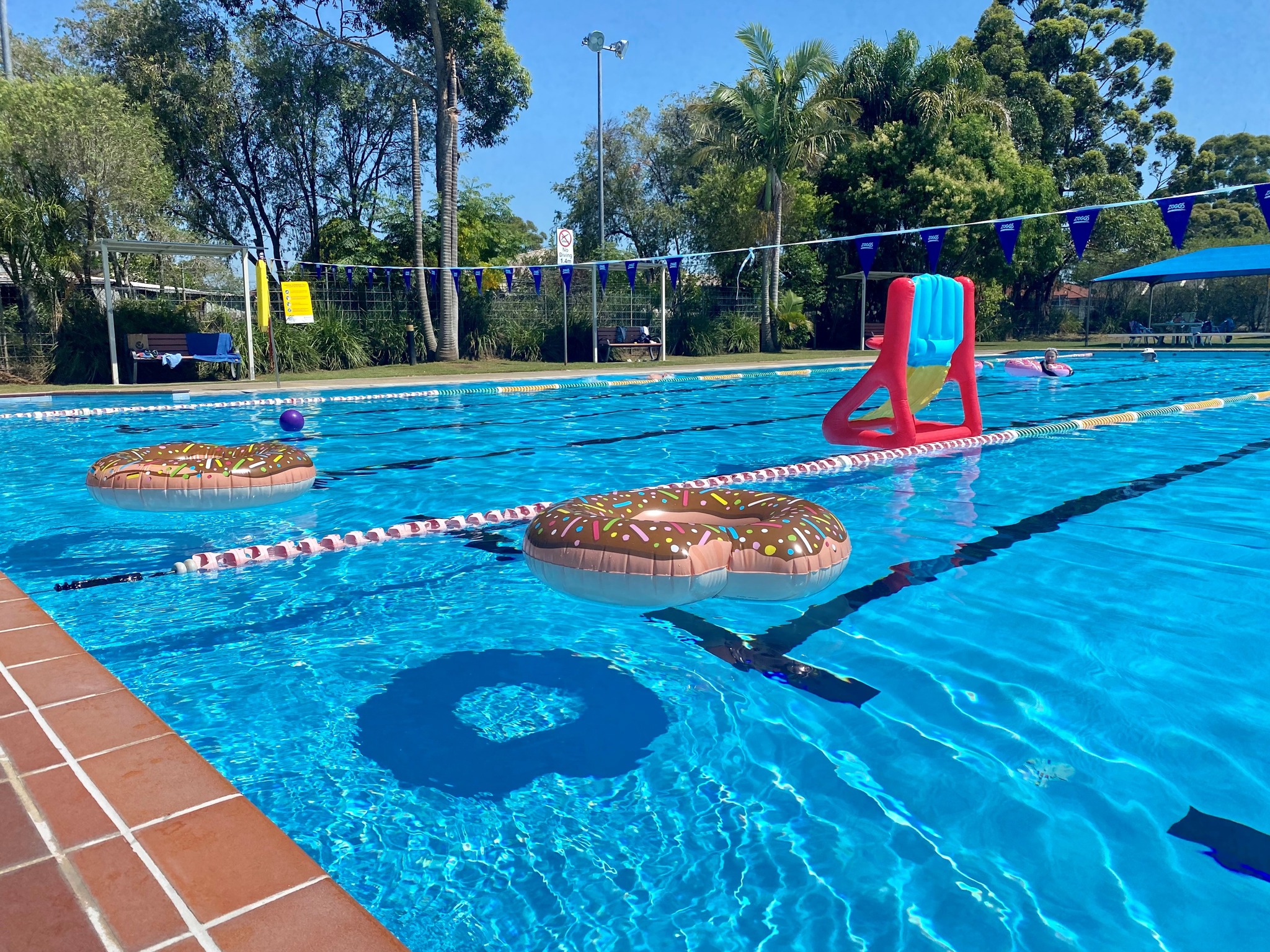 Featured are two inflatable donut rings in the outdoor swimming pool at Tilligerry Aquatic Centre
