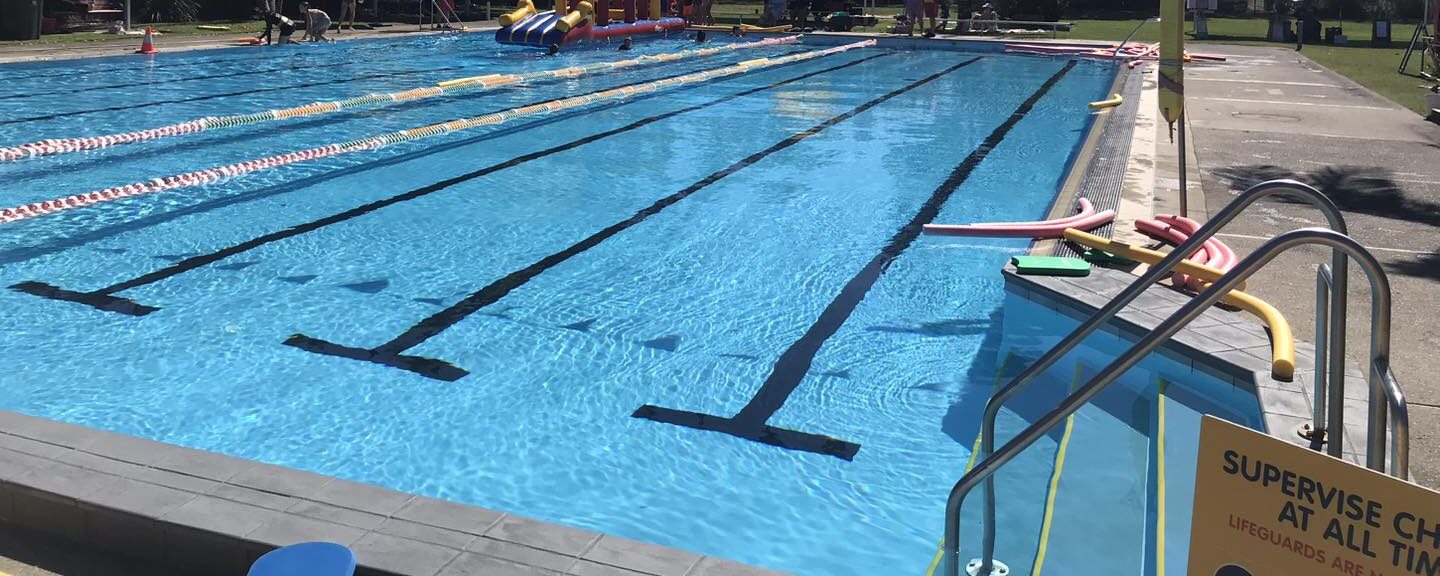 Featured is the 25m outdoor swimming pool at Tilligerry Aquatic Centre. It is a close up shot of the pool water and lanes.