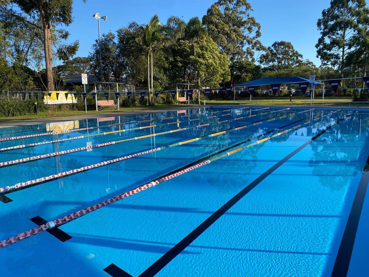 Featured is an empty pool in the late afternoon. It is the 25m outdoor heated pool at Tilligerry Aquatic Centre.